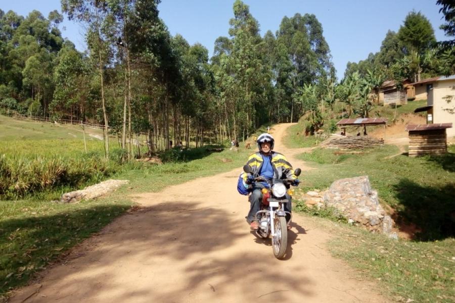 Photo of Ron P riding through a village
